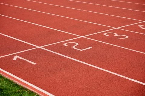 Empty red running track with numbered lanes Stock Photos