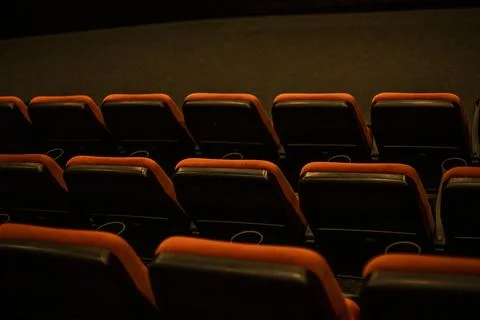 Empty red soft seats in the cinema after watching a film Stock Photos