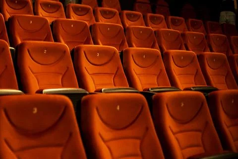 Empty red soft seats in the cinema after watching a film Stock Photos