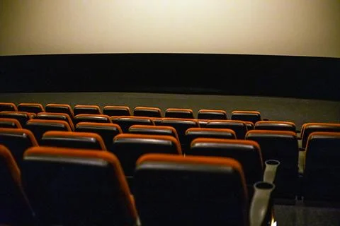 Empty red soft seats in the cinema after watching a film Stock Photos