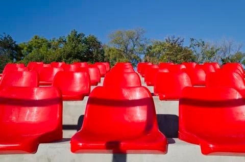 Empty red stadium seats in an open space Stock Photos