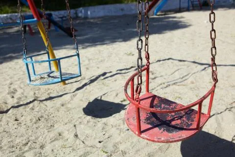 Empty red swing Stock Photos