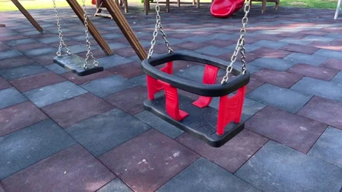 Empty red swing on a playground, outdoor recreation Stock Footage 342986563