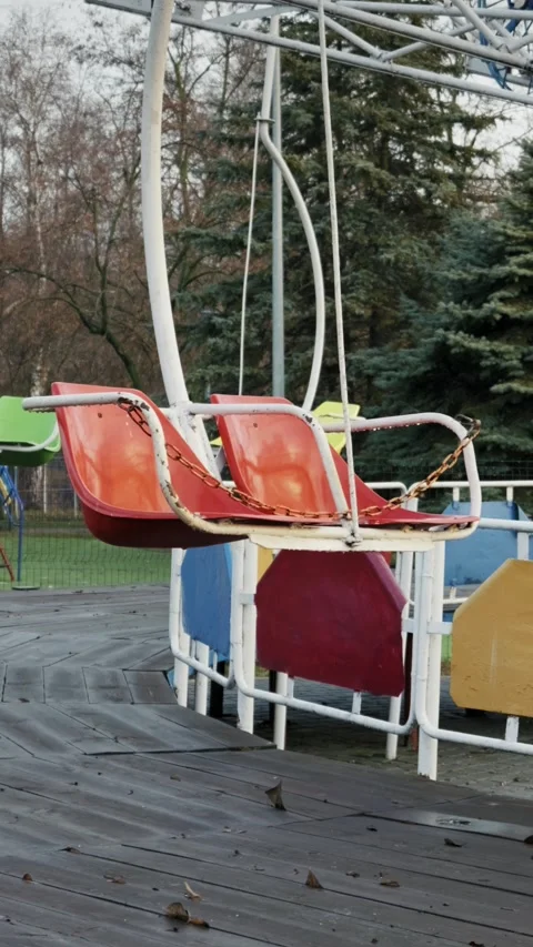 Empty Red Swing Ride in Abandoned Amusement Park Stock Footage 325967359