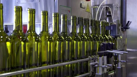 Empty red wine bottles on a coveyer belt ready for filling in South Australia Stock Footage 131308347