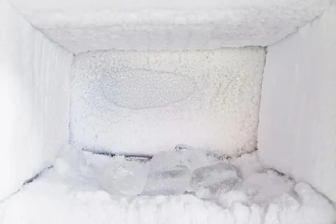 Empty of a refrigerator. Ice buildup inside of a freezer walls. Stock Photos