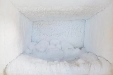 Empty of a refrigerator. Ice buildup inside of a freezer walls. Stock Photos