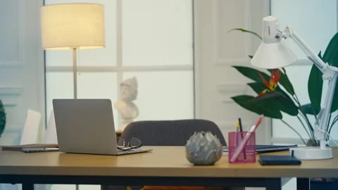 Empty remote work setup with laptop and desk lamp, freelancer's workspace Stock Footage 313720073