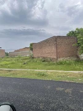 Empty Residential Plot with an Unfinished Brick Wall Stock Photos