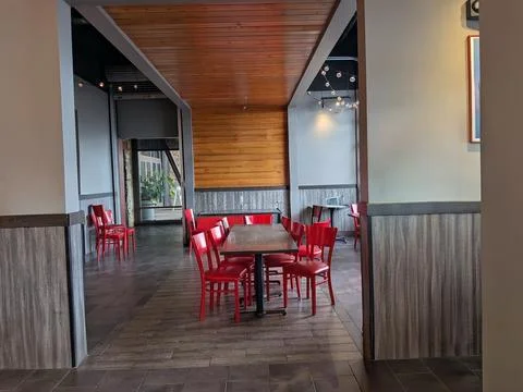Empty restaurant dining area with neatly arranged tables Stock Photos
