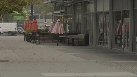 Empty restaurant during pandemic. Tables with umbrellas outside. Stock-Footage 140294829