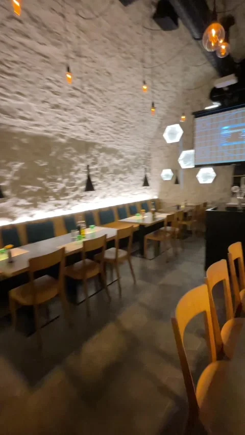 Empty restaurant interior with textured stone wall and inward camera pan, with Stock Footage 344881884