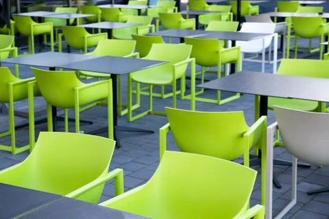 Empty restaurant or cafe with green chairs empty because of the coronavirus c Stock Photos