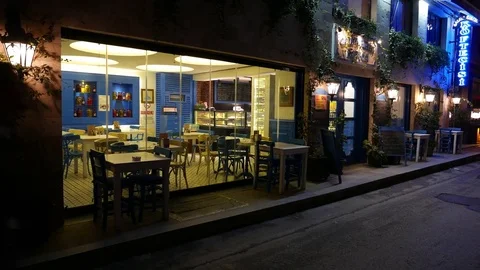 Empty restaurant room seen from dark street, people pass by at Mumhane street Stock Footage 85037396