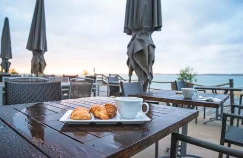 Empty restaurant with umbrella in front of the sea Stock Photos