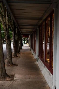 Empty retail storefront covered sidewalk Stock Photos