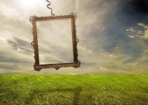 Empty retro frame hanging on poor grassy land. conceptual. Stock Illustration