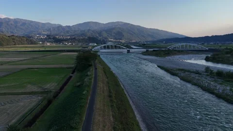 Empty River Levee Path Toward Two Distant White Bridges Vídeo Stock 347931411