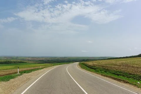 Empty road among agricultural fields in the Anapa district of the Krasnodar r Stock Photos