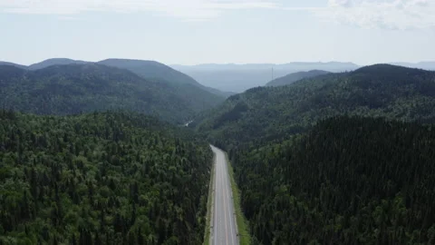 An empty road and mountains are seen in the distance from a bird's perspective 스톡 동영상 139414934