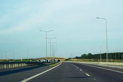 Empty road and stone bridge in distance Foto stock