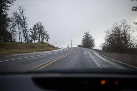 Empty road and trees from inside a car Stock Photos