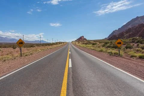 Empty road in Argentina towards the border with Chile in the Andes. Stock Photos