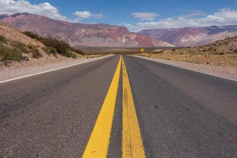 Empty road in Argentina towards the border with Chile in the Andes. Stock Photos