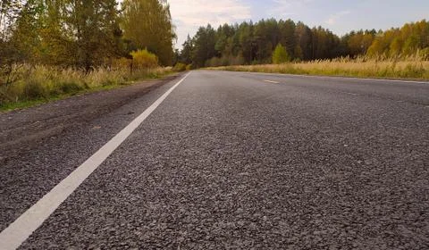 Empty road in the autumn landscape Stock Photos