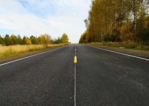 Empty road in the autumn landscape Stock Photos