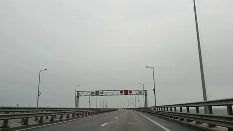An empty road on a bridge over the sea on a cloudy day. flying gulls Stock Footage 128701212