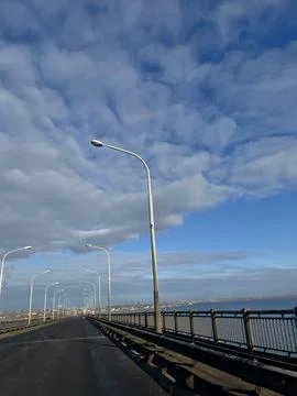 Empty Road on a Bridge Under a Cloudy Sky Stock Photos