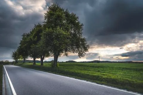 Empty road on a cloudy day. Stormy summer frame Stock Photos