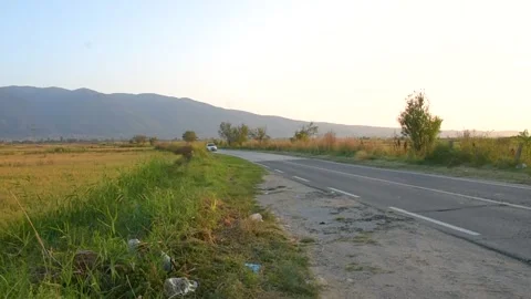 Empty road in countryside, Mountains and rice fields in background Stock Footage 253226330