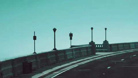 Empty road curves over bridge in daytime with no cars around Stock Footage 338322902