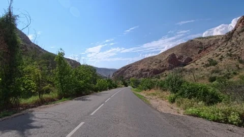 Empty road curves into valley surrounded by hills Stock Footage 340076361