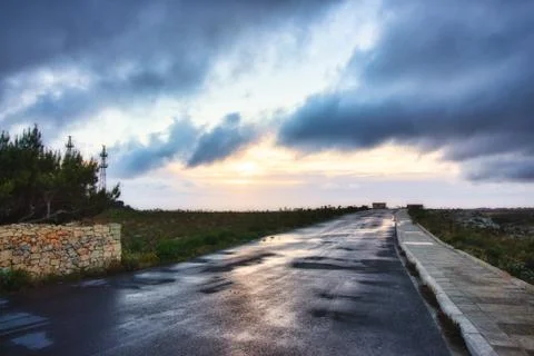 An empty road with a dramatic sky with moody clouds in the background Stock Photos