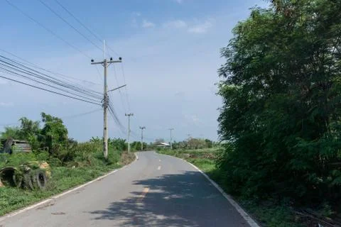 Empty road with electric wire and post and motorbike on the street. Stock Photos