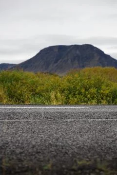 Empty road in front of a mountain range with fog. Lovely landscape and toug.. Stock Photos