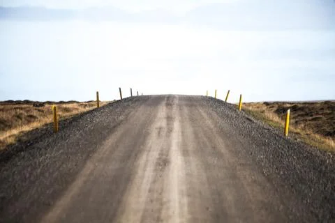 Empty road in front of a mountain range with fog. Lovely landscape and toug.. Stock Photos