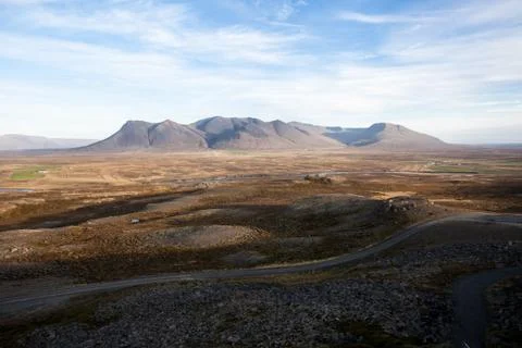 Empty road in front of a mountain range with fog. Lovely landscape and toug.. Stock Photos