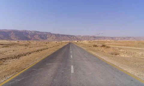 The empty road going through Israel's Judean desert, close to Palestine. Stock Photos