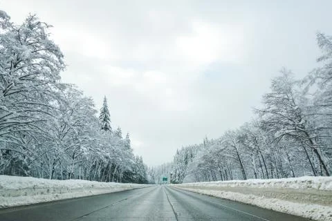 Empty road with high snow level covered landscape in winter season. Stock Photos