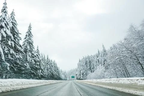 Empty road with high snow level covered landscape in winter season. Stock Photos