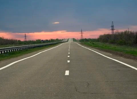Empty road to horizon at the evening Stock Photos