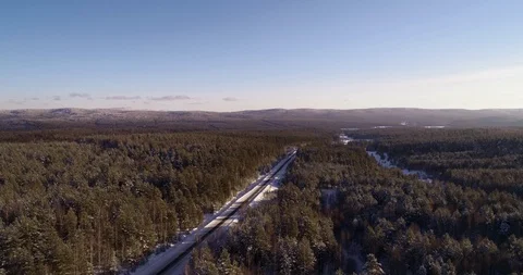 Empty road in the middle of a frozen and snow-covered forest Stock Footage 104482796