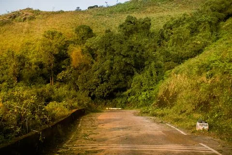 An empty road passing through the hills at Chikmagalur,karnataka. Stock Photos