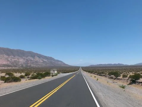 An empty road passing through the los cardones national park Fotos de archivo