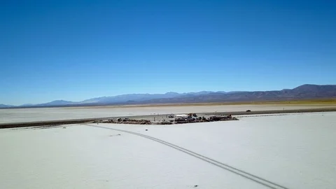 Empty road on SALT DESERT with adobe house and tourists aerial footage Stock Footage 88436033