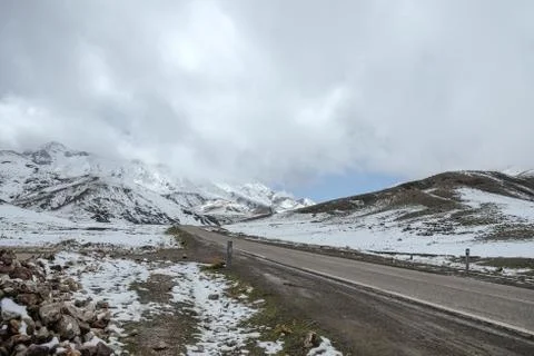 An empty road with snow capped mountains in the High Atlas range. Morocco. Stock Photos